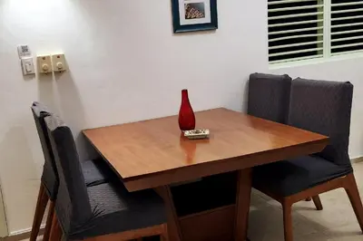 a wooden table with a vase on top of it at KERY-OASIS 2bdr with pool close to the Beach in Las Terrenas