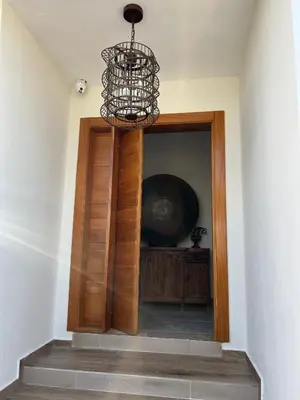 a chandelier hanging over a hallway with a door at Villa con Piscina en la Romana in La Romana