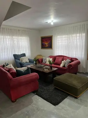 a living room with two red couches and a coffee table at Villa con Piscina en la Romana in La Romana