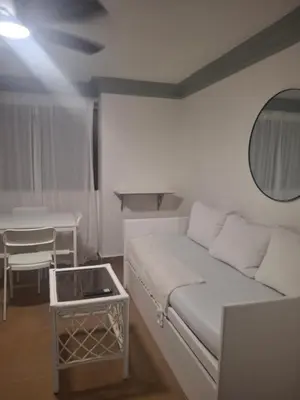 a living room with a white couch and a table at Amazing condo in the hearth of Sosua PERFECT LOCATION in Sosúa