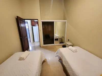 a room with two beds and a mirror at Remanso 1 in Jarabacoa