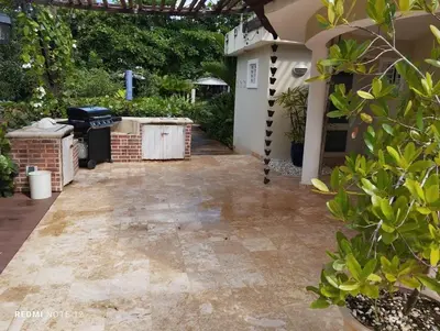 a backyard with a stone walkway leading to a house at Family Villa at Las Galeras, Samaná in Las Galeras