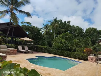 a swimming pool in the middle of a yard at Family Villa at Las Galeras, Samaná in Las Galeras