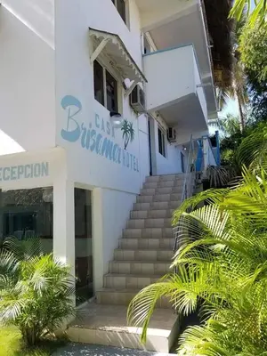 a white building with stairs in front of it at Casa Brisa Mar Hotel in Las Terrenas