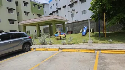 a car parked in a parking lot with a gazebo at Family Relaxation in San Isidro