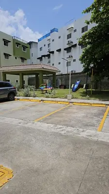 an empty parking lot in front of a building at Family Relaxation in San Isidro