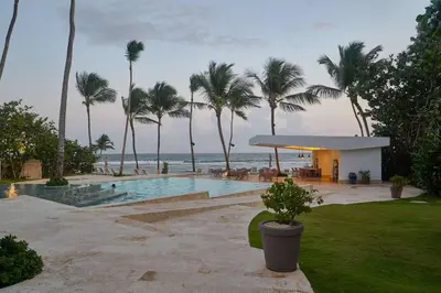 a resort with a pool and palm trees and the ocean at Luxurious Caribbean Aquarella 10th in La Puntica de Juan Dolio