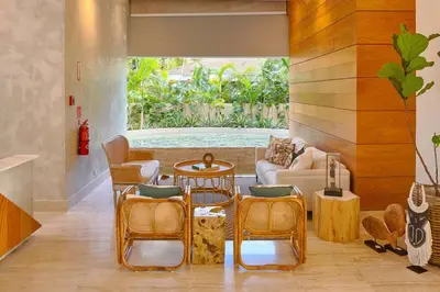 a living room with chairs and a cat sitting on a couch at Luxurious Caribbean Aquarella 10th in La Puntica de Juan Dolio