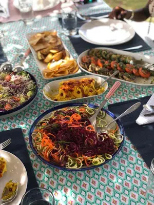 a table with many plates of food on it at Ki-Ra Holistic Living in Boca de Chavón