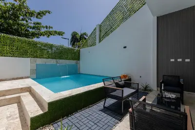 a swimming pool in the backyard of a house at PERLA I -Modern Private Villa - 4 Bedrooms with Pool in Sosúa