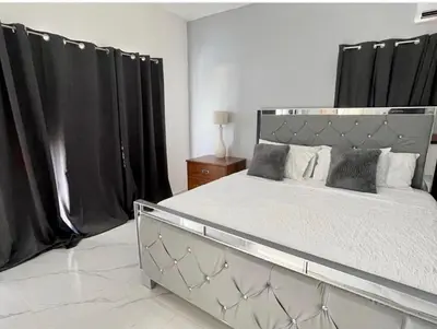a bedroom with a large bed with black curtains at Lujosa Villa in Río San Juan J in Río San Juan