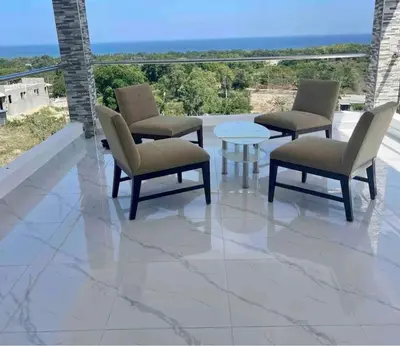 a patio with chairs and a table on a balcony at Lujosa Villa in Río San Juan J in Río San Juan