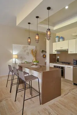 a kitchen with a large island with chairs in it at ®{The~Beach~View} @PlayaBonita BeachfrontPool in Las Terrenas