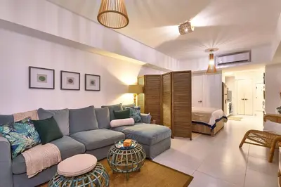 a living room with a couch and a bed at Aquarella Deluxe Caribbean Paradise in La Puntica de Juan Dolio