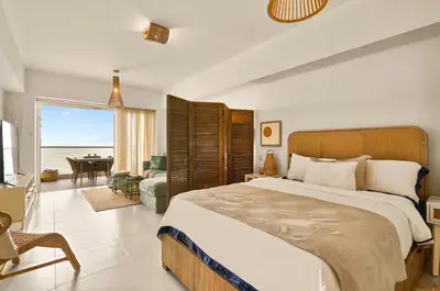 a bedroom with a bed and a view of the ocean at Aquarella Deluxe Caribbean Paradise in La Puntica de Juan Dolio