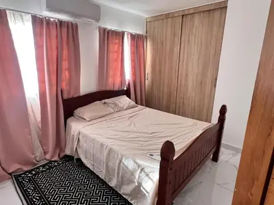 a bedroom with a large bed with pink curtains at The Ocean Romana in La Romana