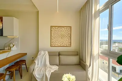 a living room with a couch and a window at Costal View Apt. Walkable To Beach & Restaurants in Juan Dolio