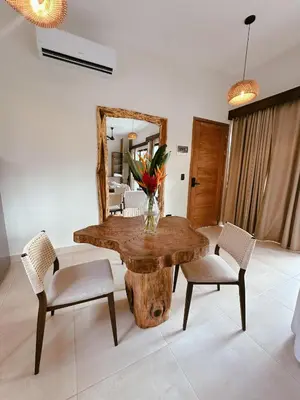 a dining room with a table and chairs and a mirror at Casa Caona in El Valle