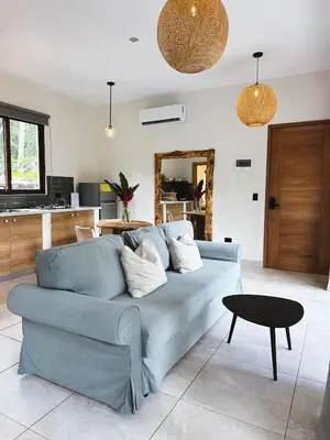 a living room with a blue couch and a table at Casa Caona in El Valle