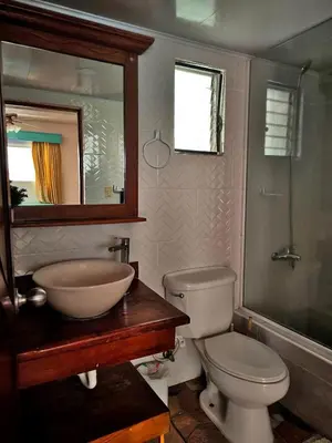 a bathroom with a sink and a toilet and a mirror at Chilvers Seaside Studio 202 in Cabarete