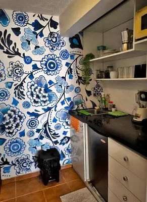 a kitchen with blue and white flowers on the wall at Chilvers Seaside Studio 202 in Cabarete