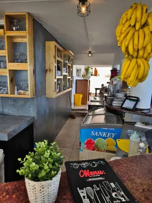 a kitchen with a bunch of bananas hanging above a counter at Chilvers Seaside Studio 202 in Cabarete