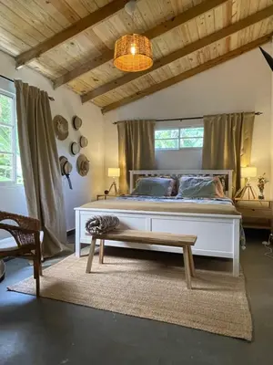 a bedroom with a large white bed and a window at Villa Linda in Polo