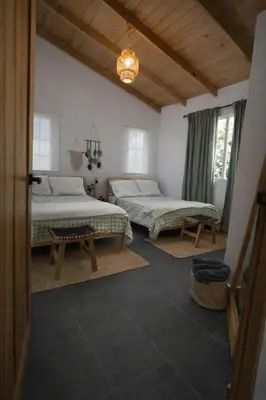 a bedroom with two beds and a chandelier at Villa Linda in Polo