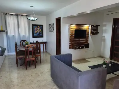 a living room with a couch and a table at Exclusive Apartment Free WiFi and Parking in Santo Domingo