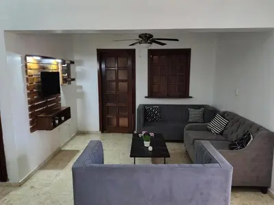 a living room with a couch and a table at Exclusive Apartment Free WiFi and Parking in Santo Domingo