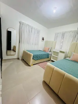 a living room with two beds and a mirror at Luxurious and comfortable 1 level in Ensanche Savica de Mendoza