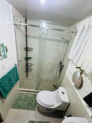 a bathroom with a shower and a white toilet at Luxurious and comfortable 1 level in Ensanche Savica de Mendoza