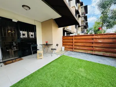 a patio with a green lawn in front of a building at Luxurious and comfortable 1 level in Ensanche Savica de Mendoza