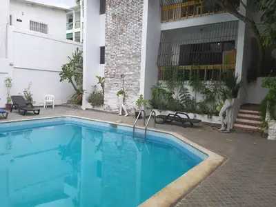 a swimming pool in front of a house at Apartment 150m from the beach with pool in Boca Chica