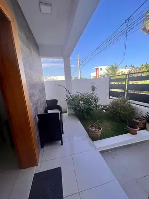 a view of a patio with a chair and plants at Popsy Villa 3 Bedrooms with Pool in Puerto Plata