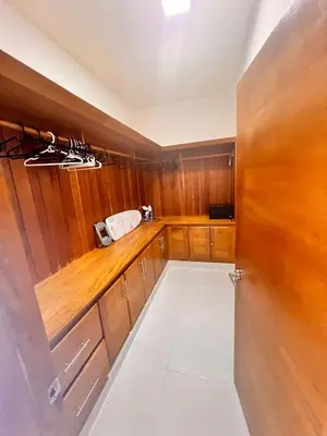 a kitchen with wooden cabinets and a counter top at Popsy Villa 3 Bedrooms with Pool in Puerto Plata