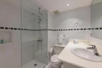 a bathroom with a shower and a sink and a toilet at Viva Heavens by Wyndham, A Trademark All Inclusive in San Felipe de Puerto Plata