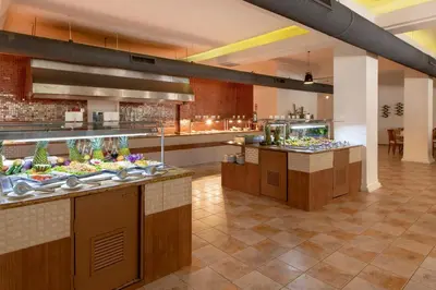a restaurant with a buffet line with food at Viva Heavens by Wyndham, A Trademark All Inclusive in San Felipe de Puerto Plata