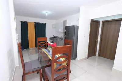 a kitchen with a dining table and a refrigerator at Peace Place in Santiago de los Caballeros