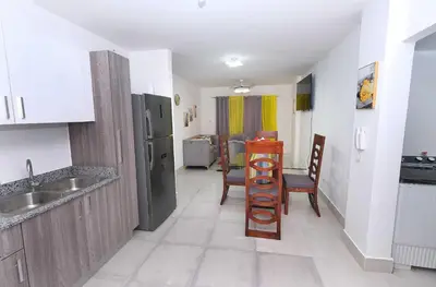 a kitchen with a sink and a table in a room at Peace Place in Santiago de los Caballeros