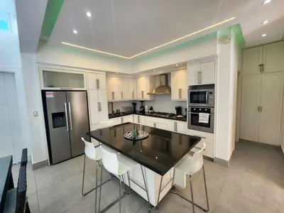 a kitchen with a table and chairs and a refrigerator at Unique 3 Bedrooms Villa las Palmas 41 in Puerto Plata