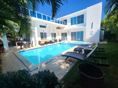 a swimming pool in front of a house at Unique 3 Bedrooms Villa las Palmas 41 in Puerto Plata