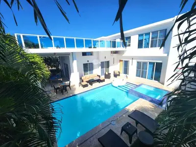 a house with a swimming pool in front of it at Unique 3 Bedrooms Villa las Palmas 41 in Puerto Plata
