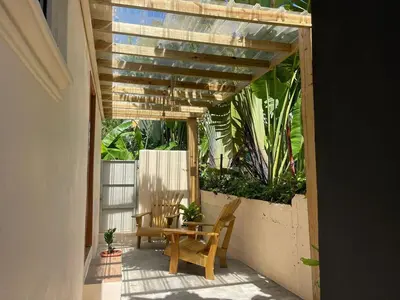 a patio with a table and chairs and plants at Guest House Canephora in Las Galeras in Las Galeras