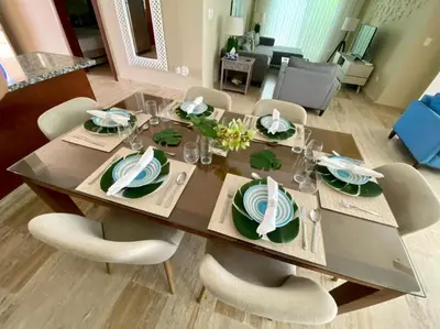 a dining room table with chairs and a dining room at Villa Serenity In The Sun in Sosúa