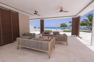a living room with a view of the beach at The beach, my happy place- One bedroom Apartment in Puerto Plata