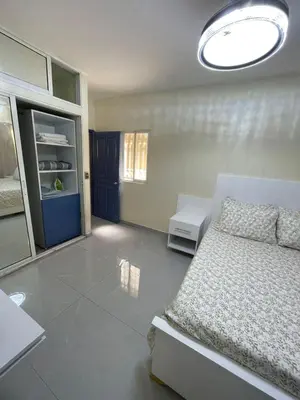 a bedroom with a bed and a blue door at Luxury apartment near Jumbo in San Pedro de Macorís