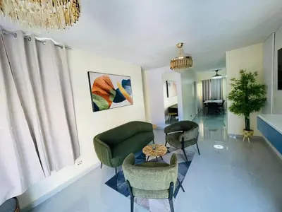 a living room with a green couch and chairs at Luxury apartment near Jumbo in San Pedro de Macorís