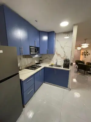 a kitchen with blue cabinets and a sink at Luxury apartment near Jumbo in San Pedro de Macorís