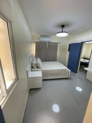 a small bedroom with a bed and a window at Luxury apartment near Jumbo in San Pedro de Macorís